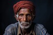 Photo of an elderly Dalit man, also in his 80s, his posture dignified despite the years of labor and struggle evident in his hands and face. Dressed in simple traditional clothing, his gaze reflects a