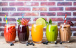 Colored funny drinks on brick background and with decor