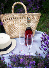 Wall Mural - two glasses and pink wine in a lavender field. Violet flowers on the background