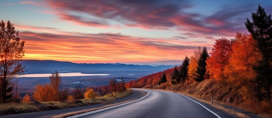 Poster - Tranquil Mountain Lake Scenery: Serene Road Nestled Amidst Majestic Peaks and Sparkling Waters