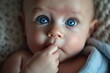 A cute newborn or infant baby grab finger in mouth and gazes wide blue eyed at the camera. Fictional Character Created by Generative AI.