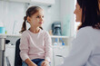 © kheat - Kid girl sitting with the pediatrician doctor. Medical examination of children