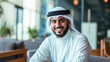 © Vladyslav - A cheerful and self-assured Arabian man, smiling while standing with crossed arms