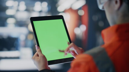 Sticker - Engineer hands scrolling green screen tablet at production factory close up.