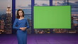 © stockbusters - Gorgeous presenter beginning broadcast breaking news near green screen tv studio