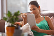 © peopleimages.com - Tablet, search and calm woman on a sofa with social media, scroll or reading ebook at home. Digital, relax and female person in a living room with streaming movie app, google it or Netflix and chill