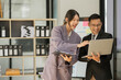 © aekachai - Asian business presents to explain the graph work on the whiteboard. Consulting, discussing, exchanging knowledge.