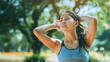 © Sasint - An exhausted and sweaty young Asian woman in sportswear is fighting the heat wave while running in a park on a sunny summer day. summer activity, heat stroke, dehydrated