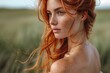 © familymedia - A portrait of a redhead woman with intense gaze in a windswept natural setting during sunset
