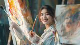 Fototapeta Sport - Creative Woman artist drawing with oil painting in her art studio, smiling carefree female making a new painting on a canvas.