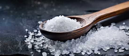 Wall Mural - Natural Sweetener: Organic Sugar Crystals in a Rustic Wooden Spoon Close-up