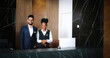 © ihorvsn - Portrait of polite, professional male and female workers of fancy hotel in uniform. Indian and African-American hotel managers smiling and looking into the camera. Customer care concept.