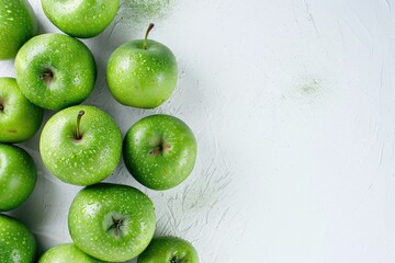 Wall Mural - Wet green apples with water drops on textured white background