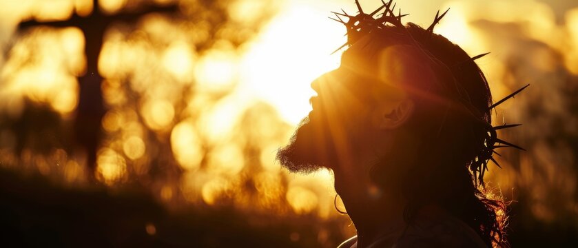 Religious Good Friday / crucifixion easter cocept, religion background banner greeting card - Silhouette portrait of Jesus Christ with crown of thorns before crucifixion, crucified, sun at the sky