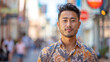 © ChubbyCat - Confident young man standing on a busy city street, with a blurred urban background.