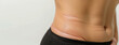 Sagging abdominal skin after weight loss. Close-up of abdomen with Fat folds, banner for plastic surgery clinic, skin tightening.