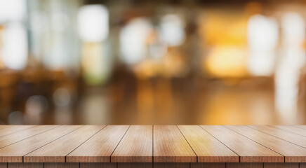 Wall Mural - Empty wooden table top with lights bokeh on blur restaurant background.