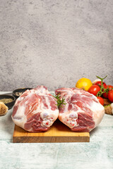 Sticker - leg of lamb Butcher products. Raw lamb leg meat with bones on stone background