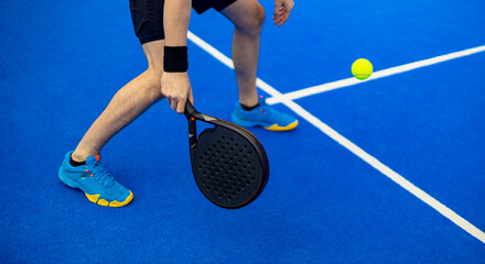 Close-up padel photo. Open Tour template. Padel tennis player on the blue court background outdoors. Paddle tenis template for bookmaker design ads with copy space. Mockup for betting advertisement.