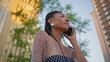 © stockbusters - Fashion lady calling phone at sunny neighbourhood closeup. African woman talking