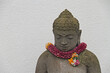Buddha figure decorated with a flower wreath for the blossom festival