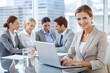 © theartcreator - Happy Businesswoman with Laptop and Blurred Colleagues in the Background