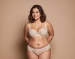 © orelphoto - A plump chubby woman in lingerie is posing over beige background