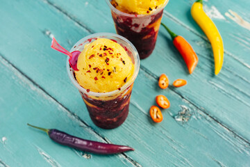 Mexican spicy fruit ice cream against colorful background