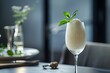 Elegant champagne sorbet served in a tall glass with a mint leaf garnish