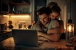 © Moonpie - Romantic couple hugging and booking a vacation together on their laptop