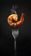 A fork with a piece of freshly fried and seasoned shrimp in centre of the frame.