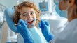 © AlfaSmart - A child looks at the dentist while the dentist examines his teeth