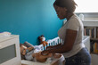 © Anna Berkut/Stocksy - mother changing diaper of baby at home