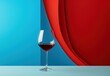 a glass of wine on a table with a blue and red wall behind it and a red and blue background behind it.
