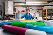 © Ibai Acevedo/Stocksy - Smiling senior worker at print shop workshop