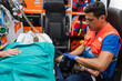 © Raul Navarro/Stocksy - paramedic treating a patient in the ambulance.