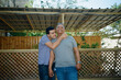 © Inna Reznik/Stocksy - Embracing Love. Teen Son Hugs Smiling Dad on Patio.