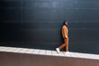 © VICTOR TORRES/Stocksy - Black man walking near wall