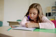 © Oleksii Syrotkin/Stocksy - Focused education elementary smart student writing