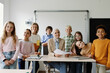 © Oleksii Syrotkin/Stocksy - GroupShot of students and schoolteacher