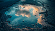 Puddles reflect the sky's moody temperament after rainfall
