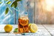 Glass jar with iced tea and lemon on wooden table