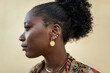 © Lupe Rodríguez/Stocksy - portrait of elegant black woman on a yellow background