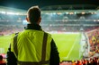 © Jan - Security staff overseeing crowded football stadium at night