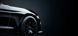 Fototapeta Miasta - Closeup on a black generic and unbranded car on a dark background, banner