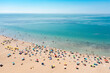 © Mauro Grigollo/Stocksy - Aerial view of people at the beach enjoying summer