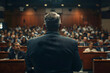 © kashiStock - an executive addressing employees during a town hall meeting to communicate company updates