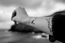 A Tattoo Of A Name Or A Date Or A Quote Related To The Hotel Or The Sea On A Wrist Or A Ankle Or A Shoulder