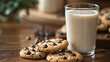 Glass of milk and chocolate chip cookies on a woo