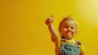 © Asad - A Toddler Giving A Thumbs Up On Yellow Background